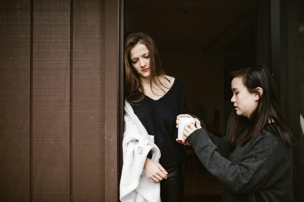 Woman Giving Coffee to a Lonely Woman