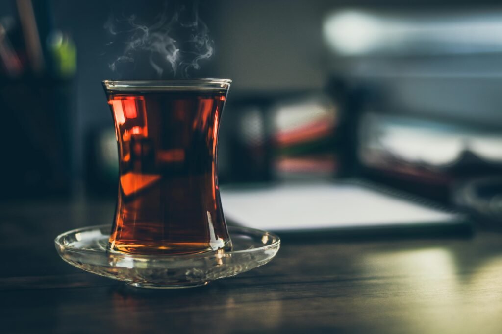 Close-up of steaming Turkish tea in a traditional glass, creating a cozy and inviting atmosphere.