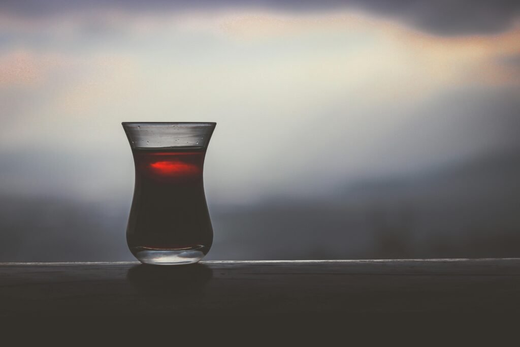 Minimalist image of Turkish tea glass silhouette with soft twilight background, offering calming ambiance.