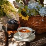 A serene outdoor tea setup with berries and vibrant flower arrangement.